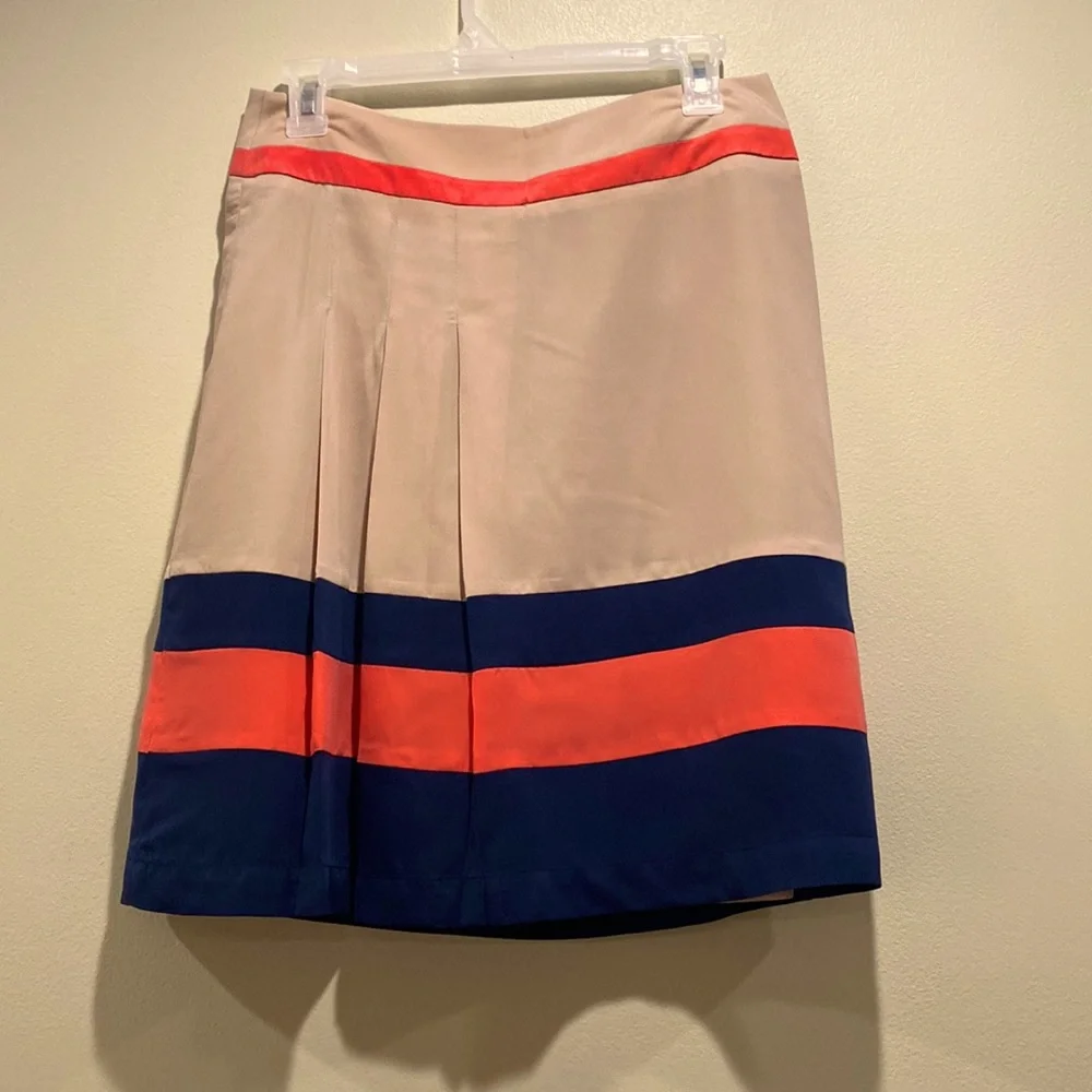 Very soft lined skirt with three pleads on the side. Size 4
